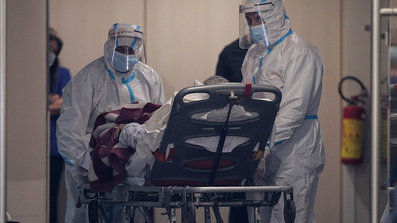 Medical personnel transfer a COVID-19 patient from a state to a private clinic which has been appropriated, in the northern city of Thessaloniki