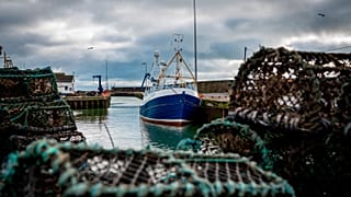 Jan. 28, 2020 photo, a fishing vessel is docked at Kilkeel harbor in Northern Ireland.