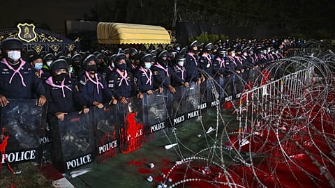 Riot police behind barricade