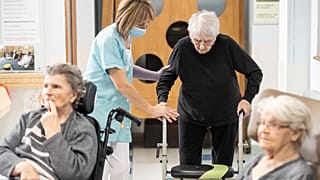 A man is helped before being tested with a PCR COVID test in a nursing home of Ammerschwihr, eastern France, Monday, Nov.9, 2020.