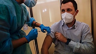 People receives flu vaccine at the Museum of science and technology in Milan, Italy, Wednesday, Nov. 4, 2020.