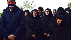  In this May 12, 2020. file photo, Serbian ambassador in Montenegro Vladimir Bozovic, left, and believers wait in front of the Christian Orthodox monastery of Ostrog.