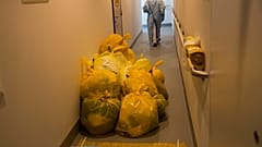 A medical worker passes by contaminated waste products in a hallway outside the intensive care ward for Covid-19 patients at the MontLegia CHC hospital in Liege.