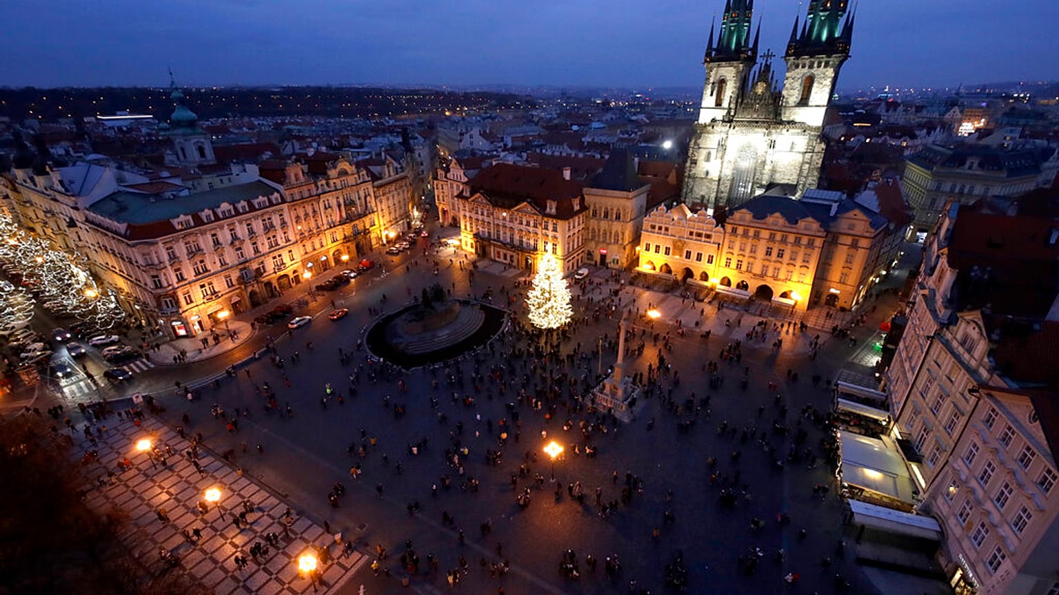 A Christmas tree illuminates the Old Town Square in Prague, Czech Republic, Saturday, Nov. 28, 2020. 
