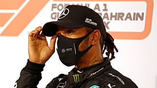 Mercedes driver Lewis Hamilton of Britain gestures after taking the pole position after the qualifying session Bahrain:  Saturday, Nov. 28, 2020 