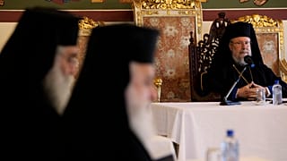 The head of Cyprus Orthodox Church Archbishop Chrysostomos II, right, presides over a meeting of other bishops composing the Holy Synod
