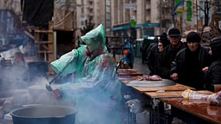 امراة توزع طعاما في ساحة الاستقلال وسط كييف. 2014/03/16
