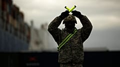 A U.S. soldier directs armoured vehicles and tanks of the 1st Armored Brigade Combat Team and 1st Calvary Division at the port of Antwerp, Belgium, Nov. 16, 2020.