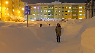 A woman walks on a cleared path