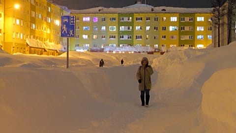 A woman walks on a cleared path