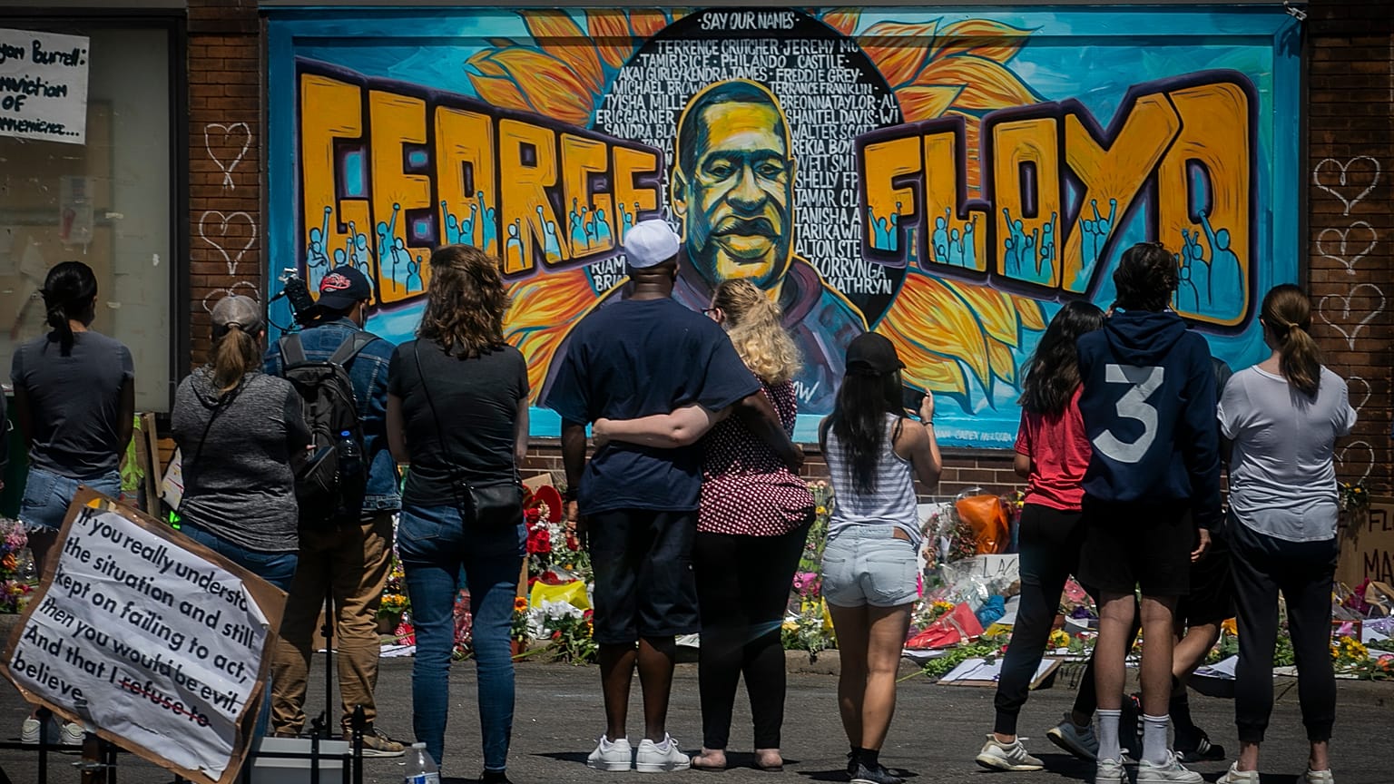  visitors make silent visits to organic memorial featuring a mural of George Floyd, near the spot where he died while in police custody, in Minneapolis.