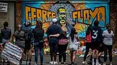  visitors make silent visits to organic memorial featuring a mural of George Floyd, near the spot where he died while in police custody, in Minneapolis.