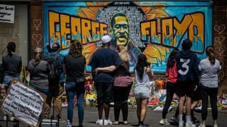 visitors make silent visits to organic memorial featuring a mural of George Floyd, near the spot where he died while in police custody, in Minneapolis.
