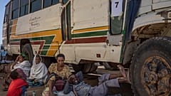 Tigray refugees wait to ride their bus going to Village 8 temporary shelter, near the Sudan-Ethiopia border, in Hamdayet, Dec. 1, 2020.