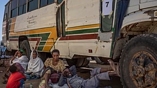 Tigray refugees wait to ride their bus going to Village 8 temporary shelter, near the Sudan-Ethiopia border, in Hamdayet, Dec. 1, 2020.