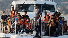 Greek Coast Guard vessel arrives carrying migrants at the port of Mytilene
