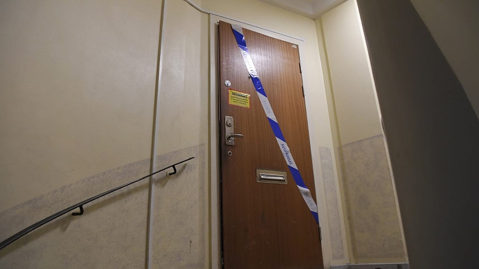Police tape fixed on the door of the apartment in Haninge, south of Stockholm.