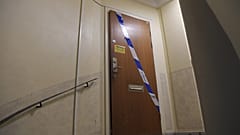 Police tape fixed on the door of the apartment in Haninge, south of Stockholm.