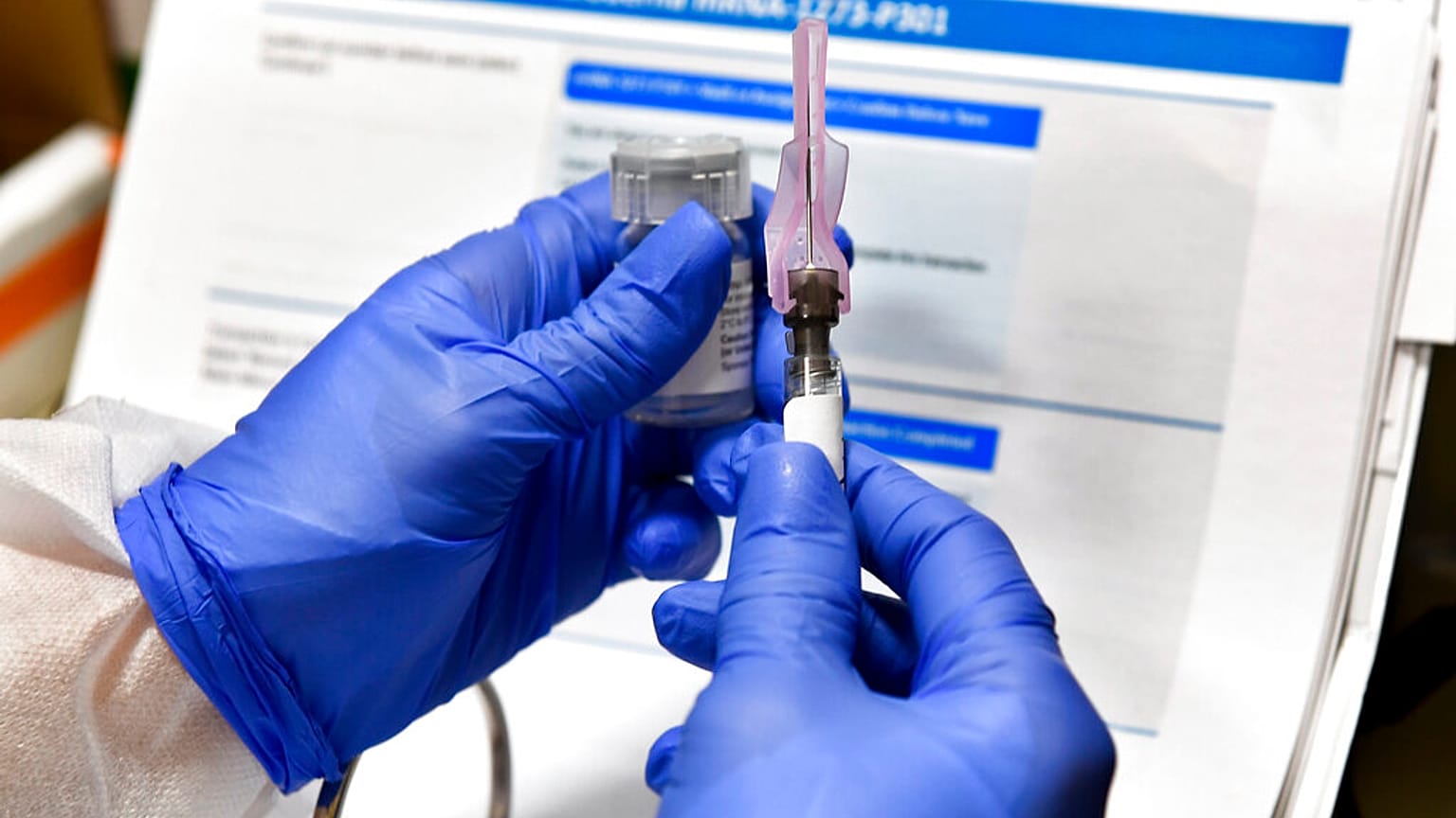 In this July 27, 2020, file photo, a nurse prepares a shot that is part of a possible COVID-19 vaccine, in Binghamton, N.Y. (AP Photo/Hans Pennink, File)