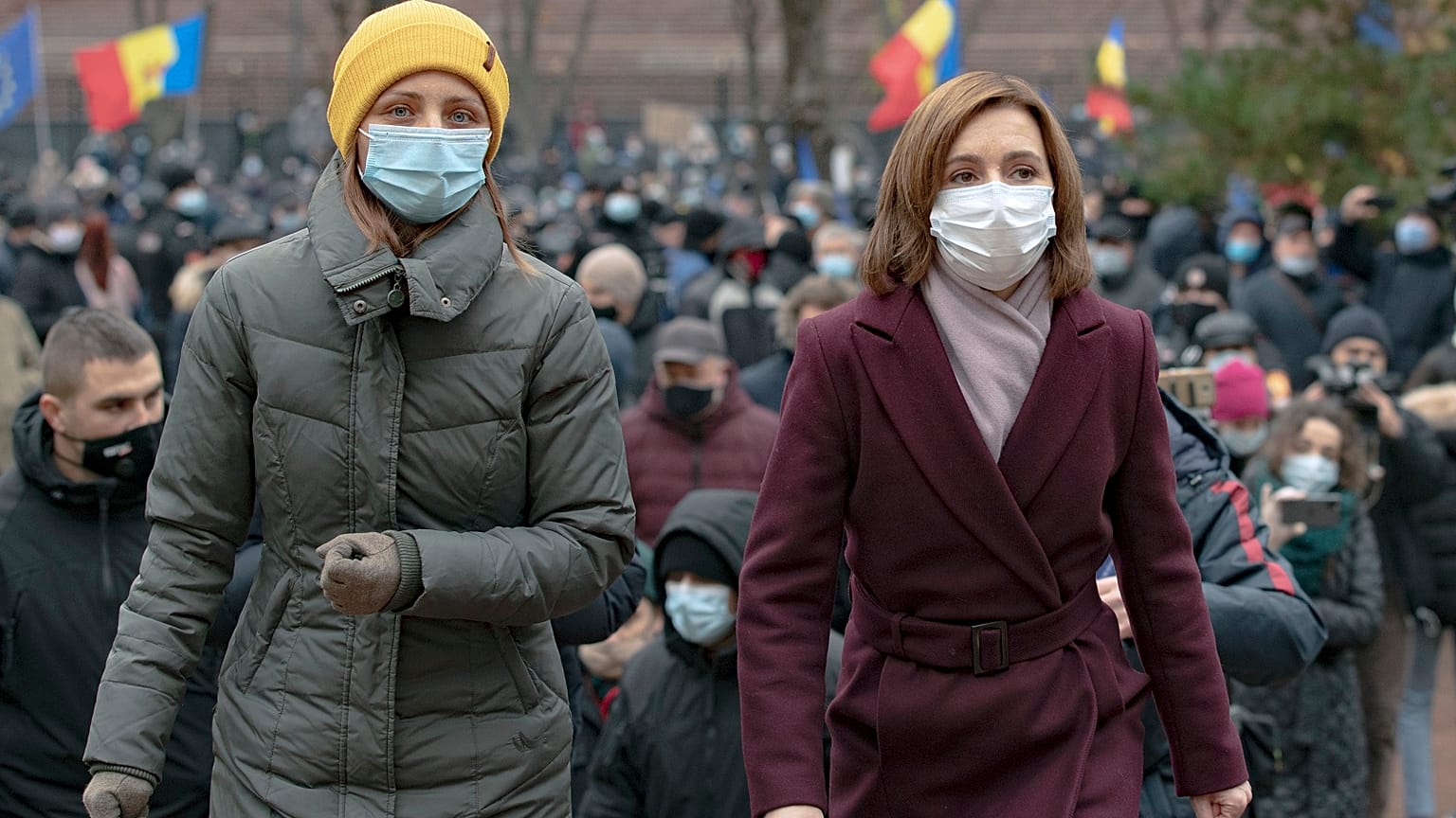 Moldova's president elect Maia Sandu, right, walks away after addressing protesters outside the parliament building in Chisinau, Moldova, Thursday, December 3, 2020.