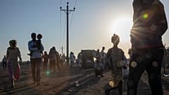 Tigray refugees who fled the conflict in the Ethiopia's Tigray walk at Hamdeyat Transition Center near the Sudan-Ethiopia border, eastern Sudan, Thursday, Dec. 3, 2020.