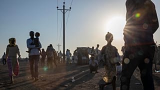 Tigray refugees who fled the conflict in the Ethiopia's Tigray walk at Hamdeyat Transition Center near the Sudan-Ethiopia border, eastern Sudan, Thursday, Dec. 3, 2020.