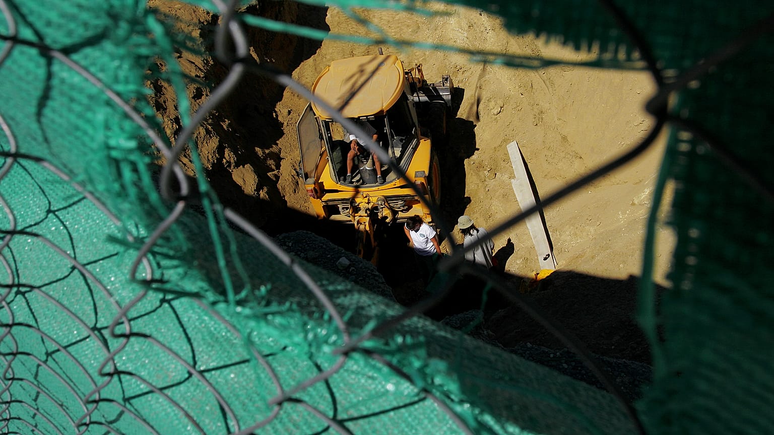 Experts search a well for remains of missing persons with the help of a bulldozer in the divided capital Nicosia