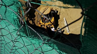 Experts search a well for remains of missing persons with the help of a bulldozer in the divided capital Nicosia