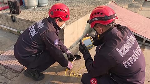 Firefighters with thermal camera looking for trapped cat.