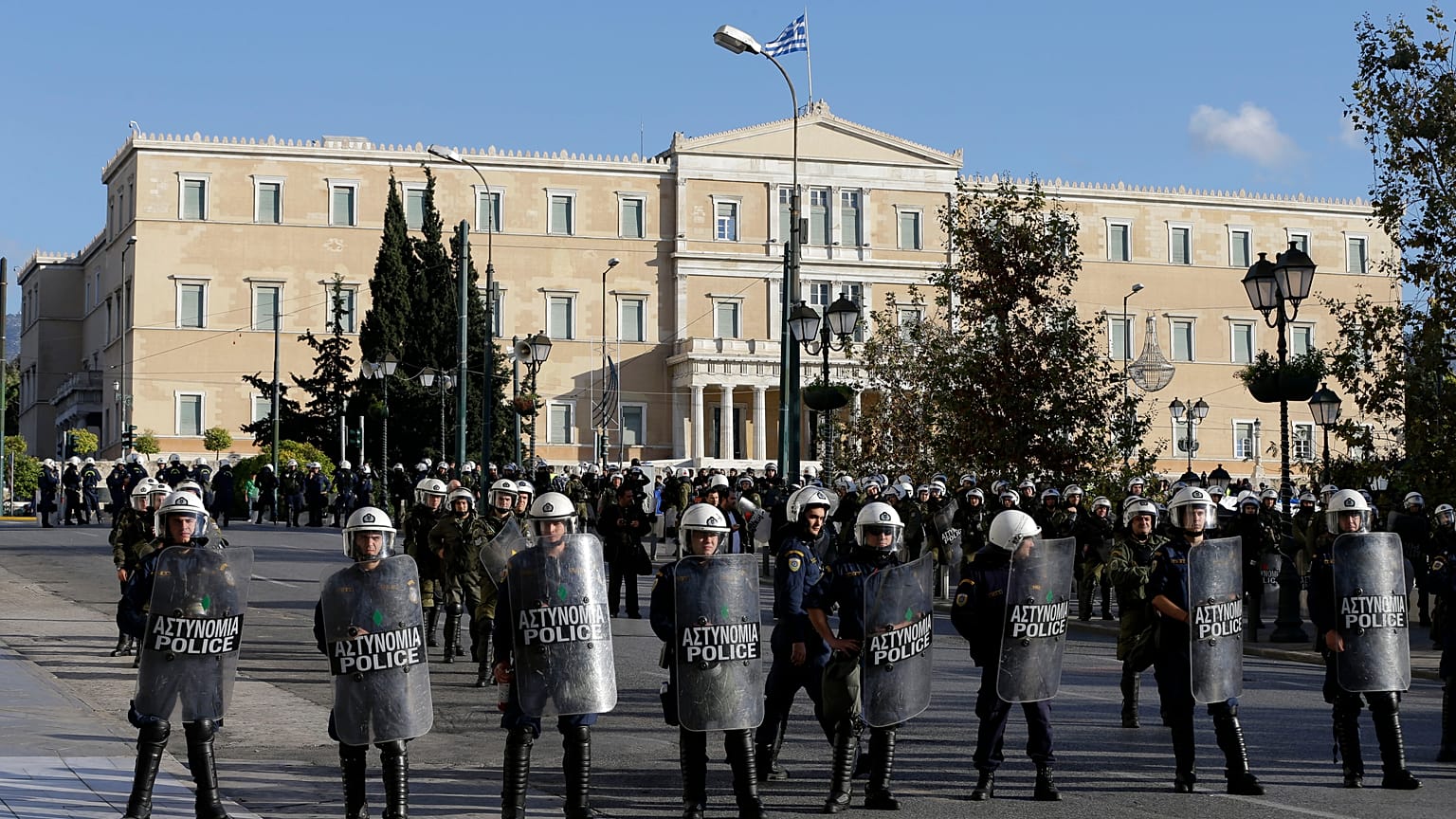 Riot police block the road outside luxury hotels