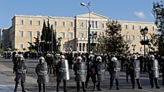 Riot police block the road outside luxury hotels