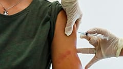 A Russian medical worker, right, administers a shot of Russia's Sputnik V coronavirus vaccine in Moscow, Russia, Saturday, Dec. 5, 2020. 