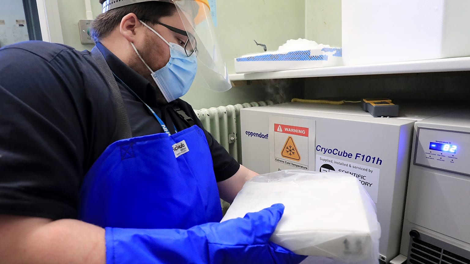 A pharmacy technician from Croydon Health Services takes delivery of the first batch of COVID-19 vaccinations at Croydon University Hospital in south London.
