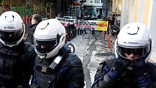 Policemen block a group of protesters as part of a general ban on gatherings, during the anniversary of the killing of a teenager 12 years ago, in Athens