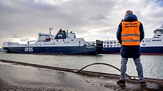 A man stand at the DFDS buffer zone before a press conference, as part of the Get Ready For Brexit campaign, at the DFDS ferry terminal at Rotterdam port, December 1, 2020.