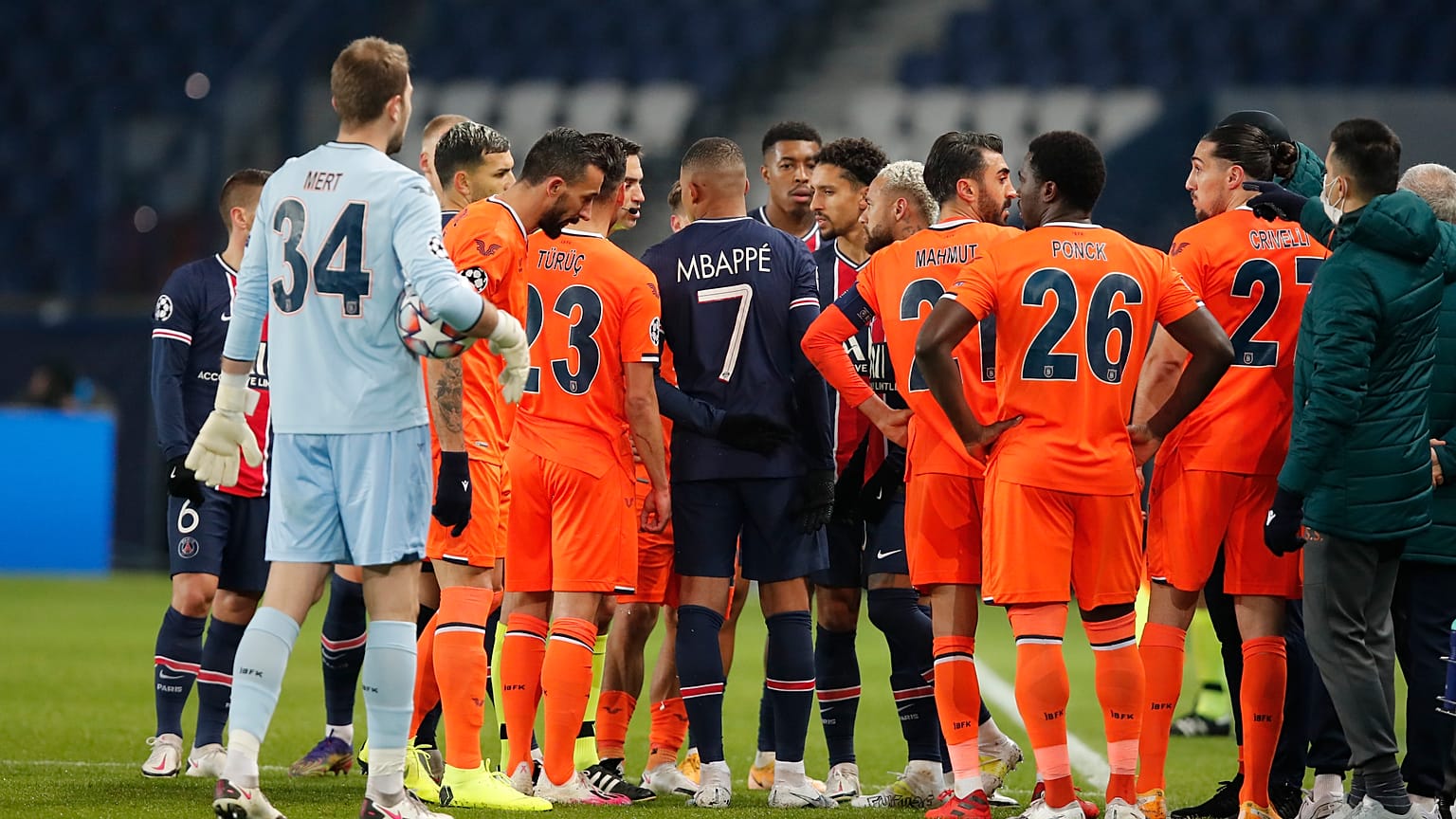 Players of Paris Saint Germain and Istanbul Basaksehir leave the pitch after an argument between the Turkish players and the fourth referee during a Champions League game.