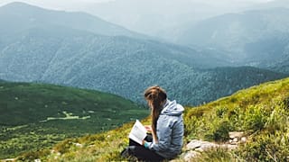 Reading climate fiction on the top of a mountain