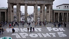 Students set up candles for the slogan'Fight for 1 point 5' during a protest of the Fridays For Future movement at the Brandenburg Gate Berlin, Germany