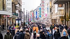 Numerous pedestrians walk through the decorated city centre in Duesseldorf, Germany, Saturday, Dec.12, 2020.