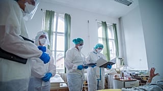 Védőfelszerelést viselő orvosok vizitelnek a koronavírussal fertőzött betegek fogadására kialakított intenzív osztályon a Szent János Kórházban 2020. december 9-én