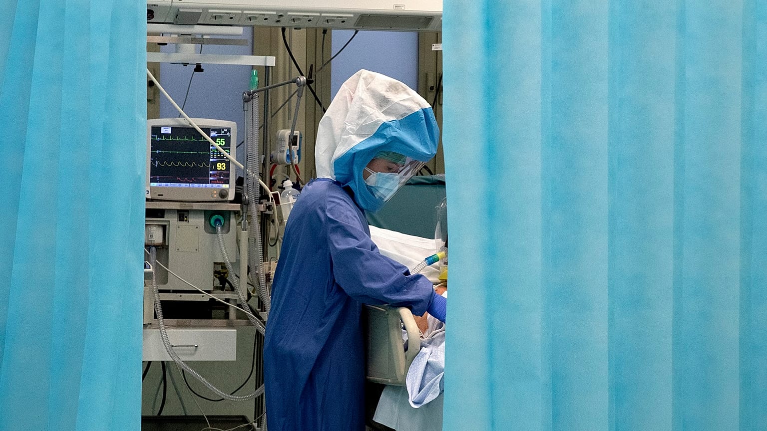 A nurse tends to a patient inside a COVID-19 intensive care unit of the Tor Vergata Polyclinic Hospital in Rome, Sunday, Dec. 13, 2020.