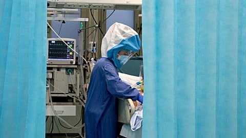 A nurse tends to a patient inside a COVID-19 intensive care unit of the Tor Vergata Polyclinic Hospital in Rome, Sunday, Dec. 13, 2020.