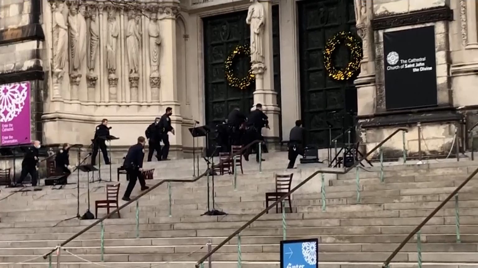Police officers approach cathedral