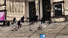 Police officers approach cathedral