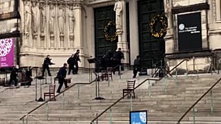 Police officers approach cathedral