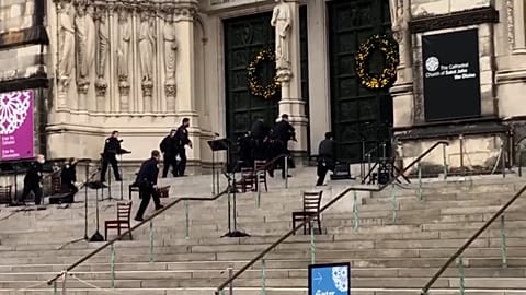 Police officers approach cathedral
