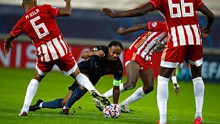 Manchester City's Raheem Sterling, centre, challenges for the ball with three Olympiakos players
