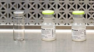 file photo shows vials used by pharmacists to prepare syringes 