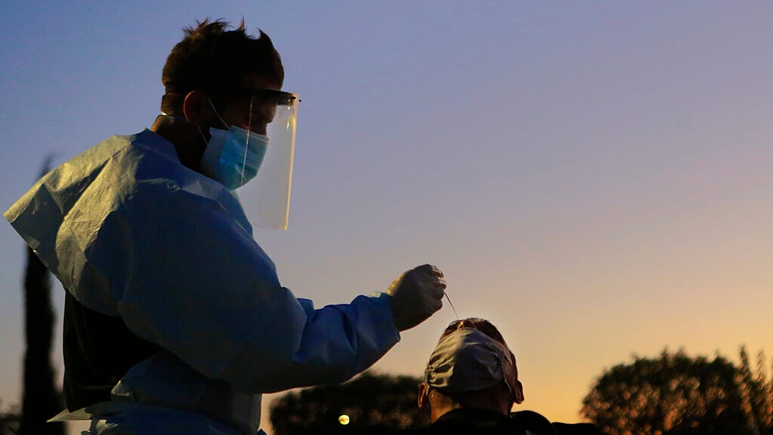 A health worker carries out a rapid coronavirus test at a car-parking in Lakatamia a suburb west of capital Nicosia
