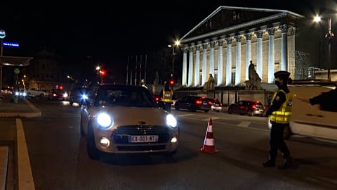 Police check motorists as curfew comes into force in Paris